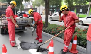 Municipal maintenance workers performing road repair — applicable scene for G808 smart safety helmet